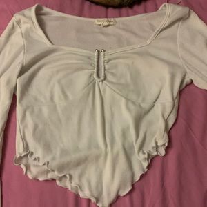 white long sleeve crop top with a metal hook in the middle on the bust part